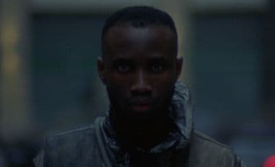 a man in a leather jacket looking at the camera