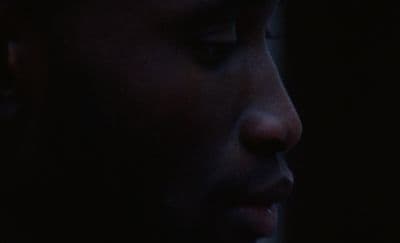 a close up of a person's face in the dark
