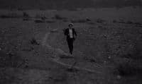 a man is running in the middle of a field