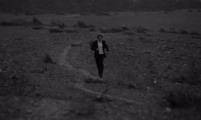 a man is running in the middle of a field