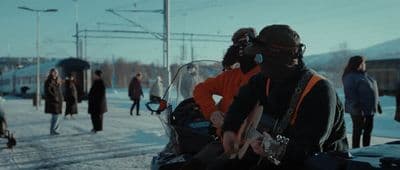 a group of people walking down a snow covered road