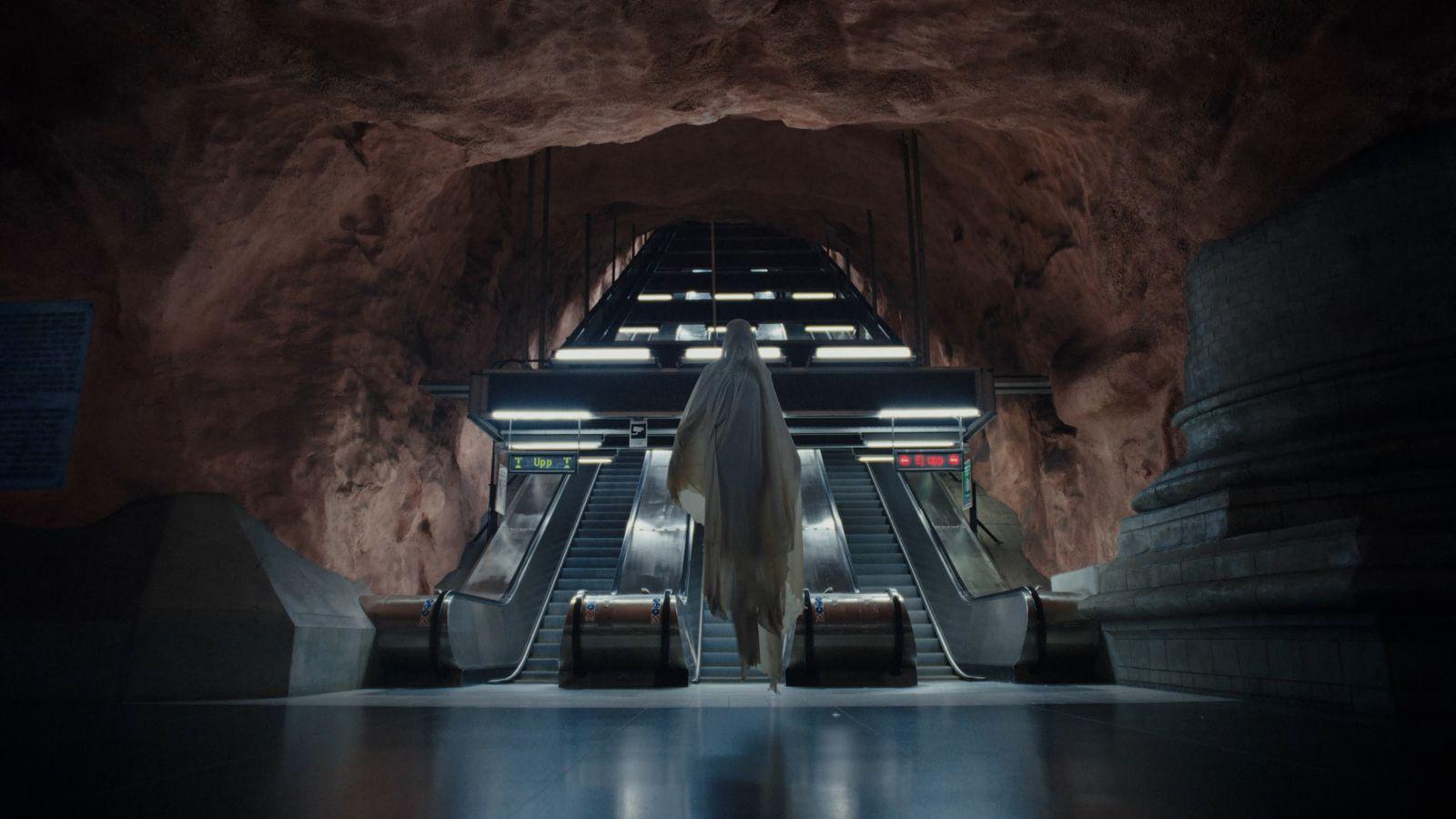 an escalator in a subway station with escalators