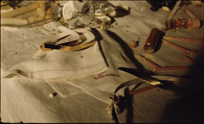 a table topped with lots of clutter and a pair of scissors