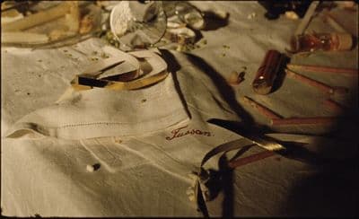 a table topped with lots of clutter and a pair of scissors