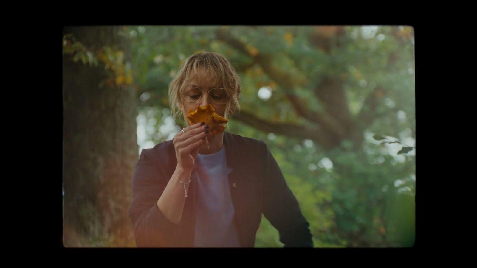 a woman holding a piece of food in her hands