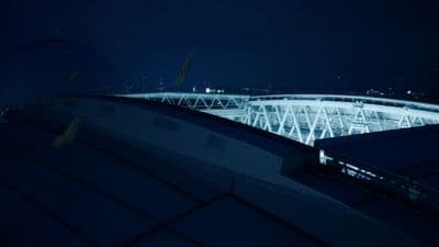 a view of a stadium at night from the roof of a building