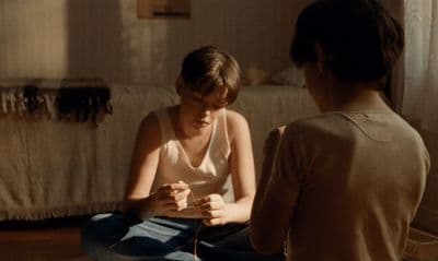 a woman sitting on the floor next to another woman