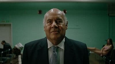 a man in a suit and tie standing in a room