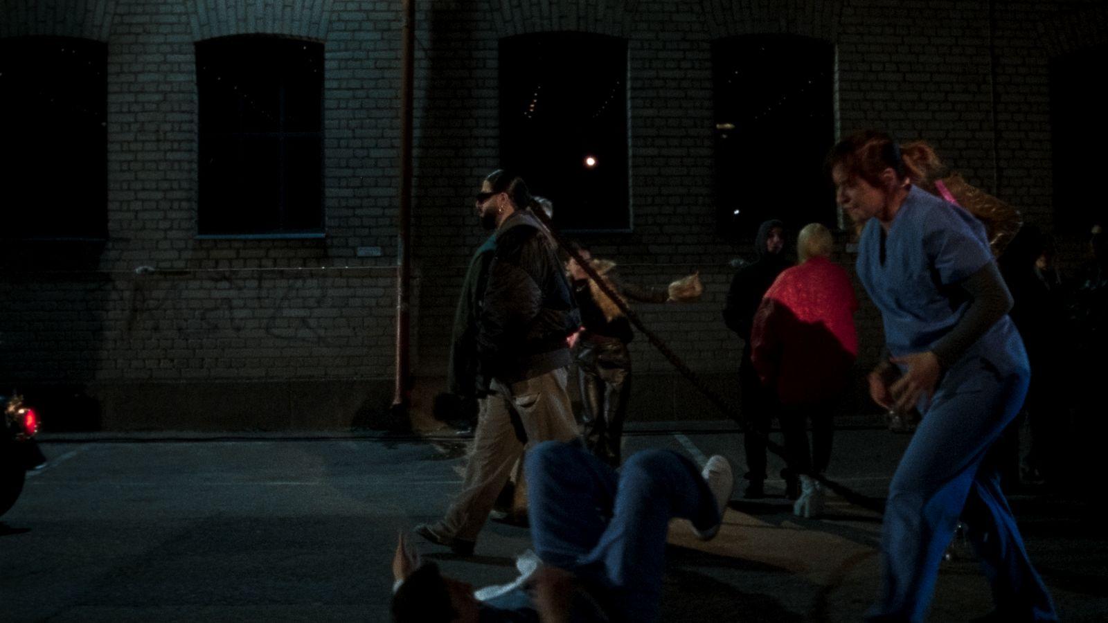 a group of people standing in a parking lot