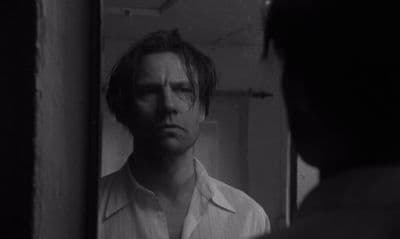 a man looking at himself in the mirror