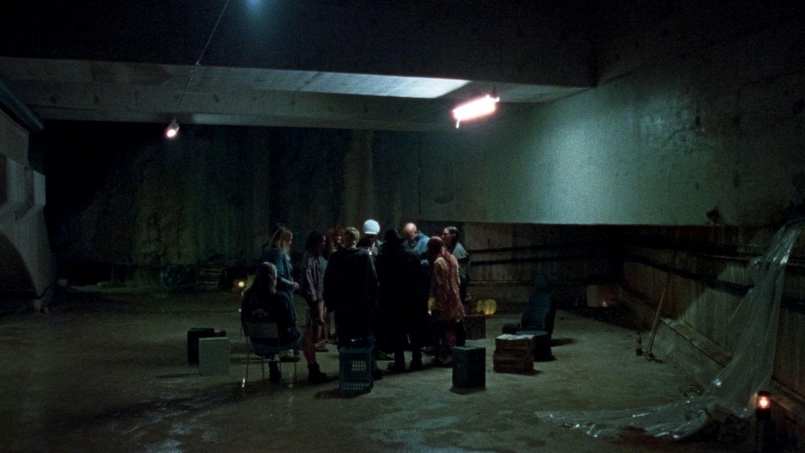 a group of people standing in a dark room