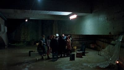 a group of people standing in a dark room