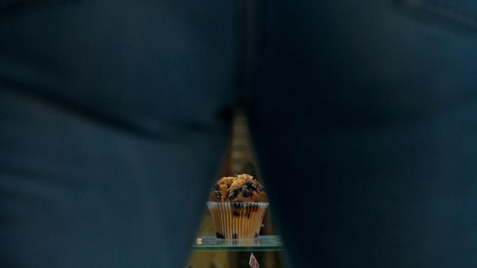 a cupcake sitting on top of a glass shelf