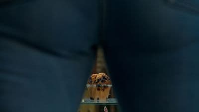 a cupcake sitting on top of a glass shelf