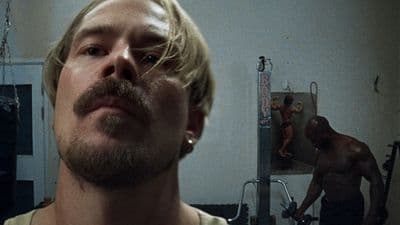 a man with a beard and no shirt in a bathroom