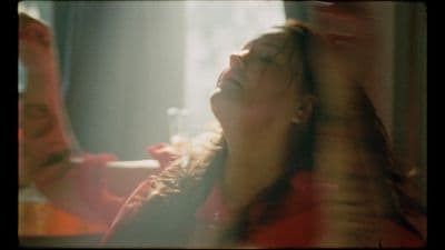 a woman with her eyes closed looking up