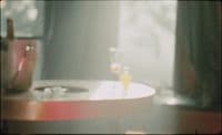 a blurry photo of a table with a wine glass