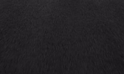 a blurry photo of a black surface with a white background