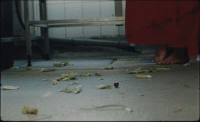 a person in a red dress standing on a floor