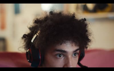 a young man with headphones on his ears
