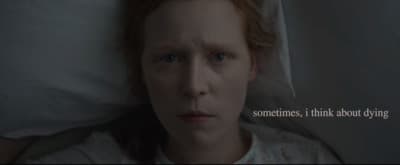 a woman laying in bed with the words sometimes, i think about dying