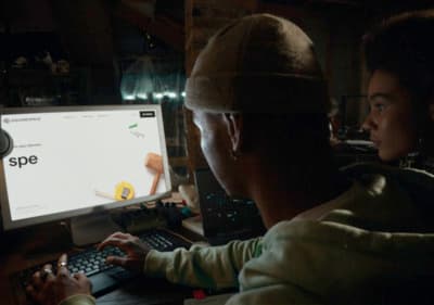 a man and a woman looking at a computer screen