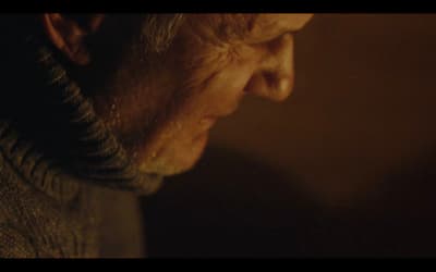 an old man with a beard and a sweater on