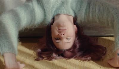 a woman is upside down on the floor