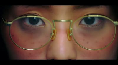 a close up of a person wearing glasses