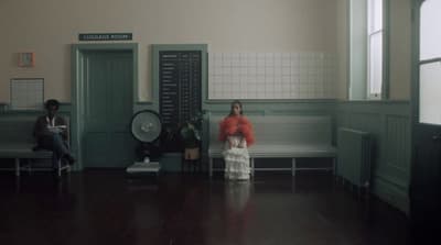 a woman and a girl sitting in a waiting room