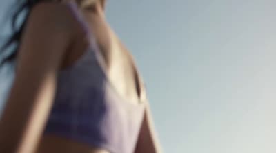 a woman in a bikini holding a frisbee
