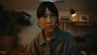 a woman is staring at the camera in a room