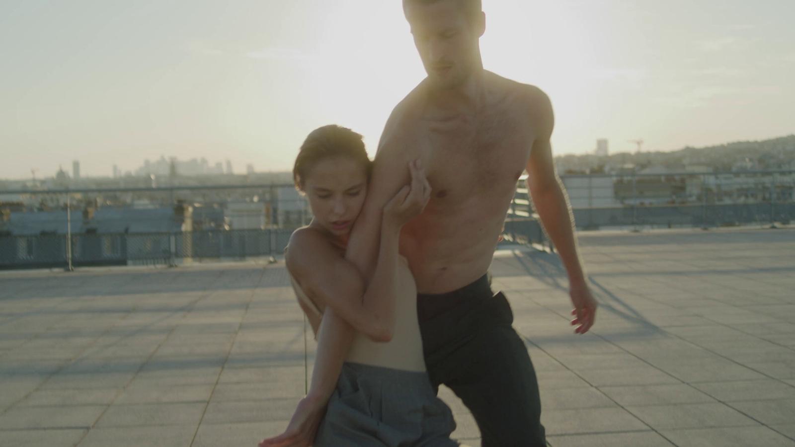 a man and a woman standing on a roof
