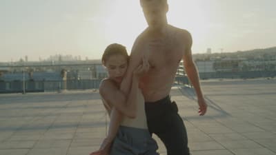 a man and a woman standing on a roof