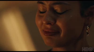a close up of a person with her eyes closed