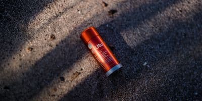 an orange lip bale sitting on the ground