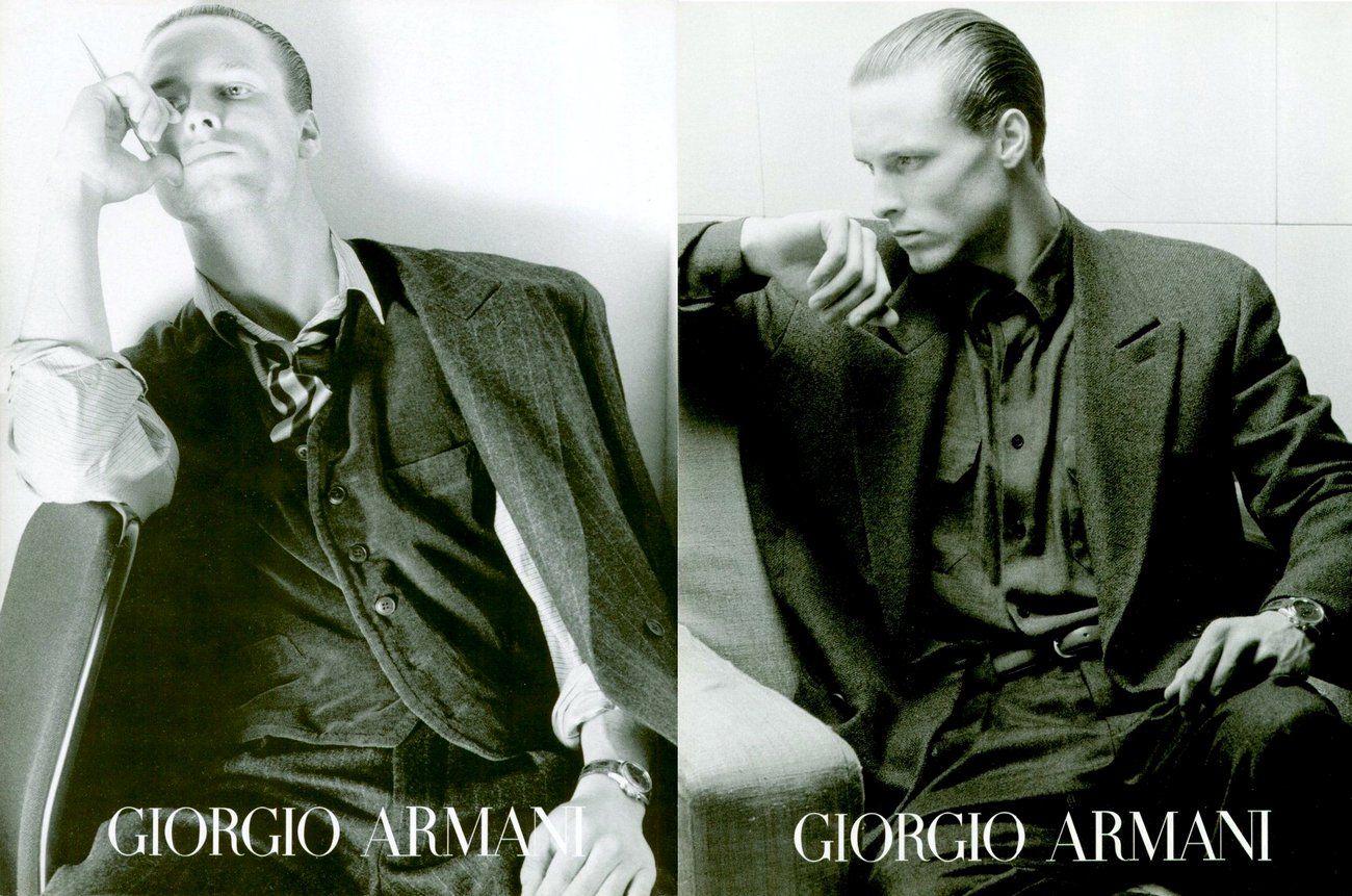 a black and white photo of two men sitting next to each other