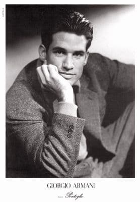 a black and white photo of a man in a sweater