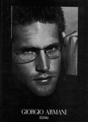 a black and white photo of a man wearing glasses