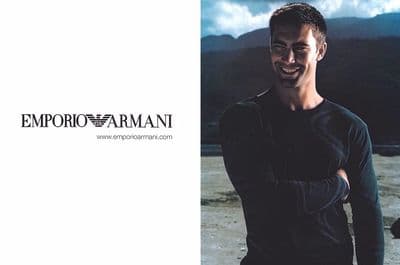a man standing in front of a mountain with his arms crossed