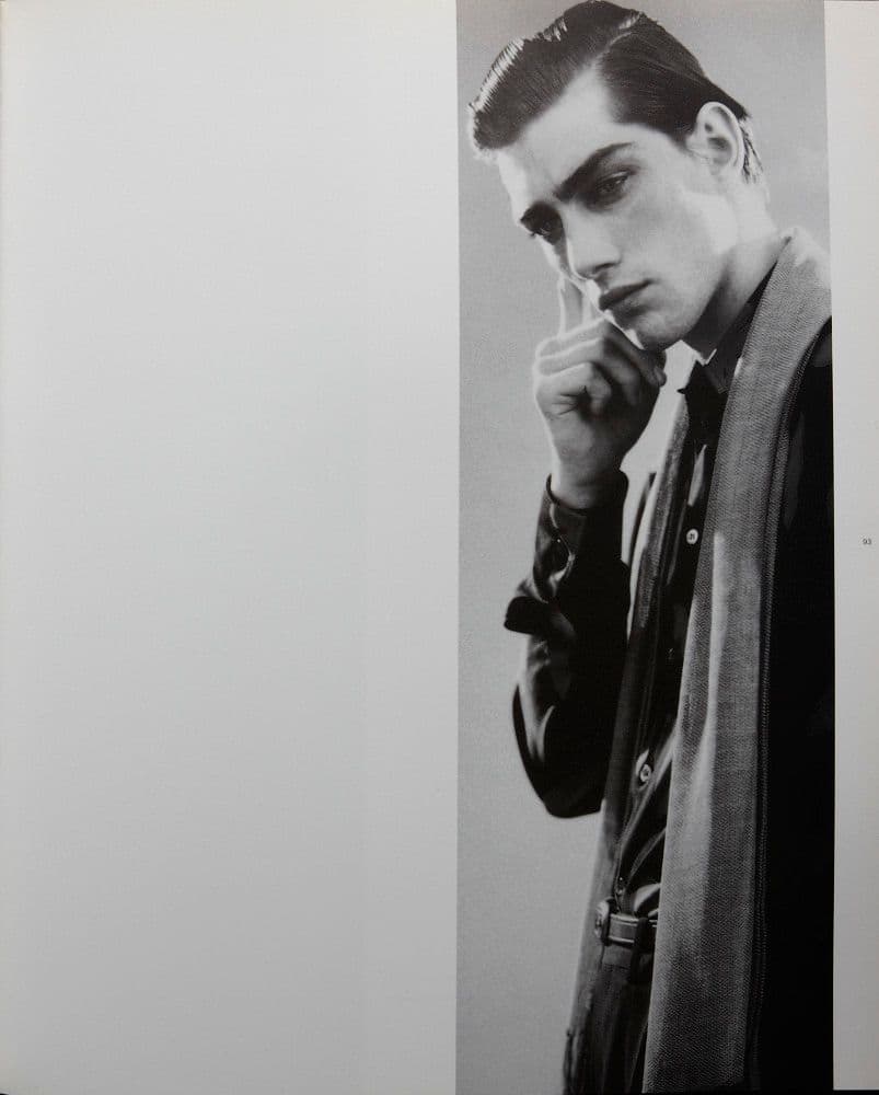 a black and white photo of a man smoking a cigarette
