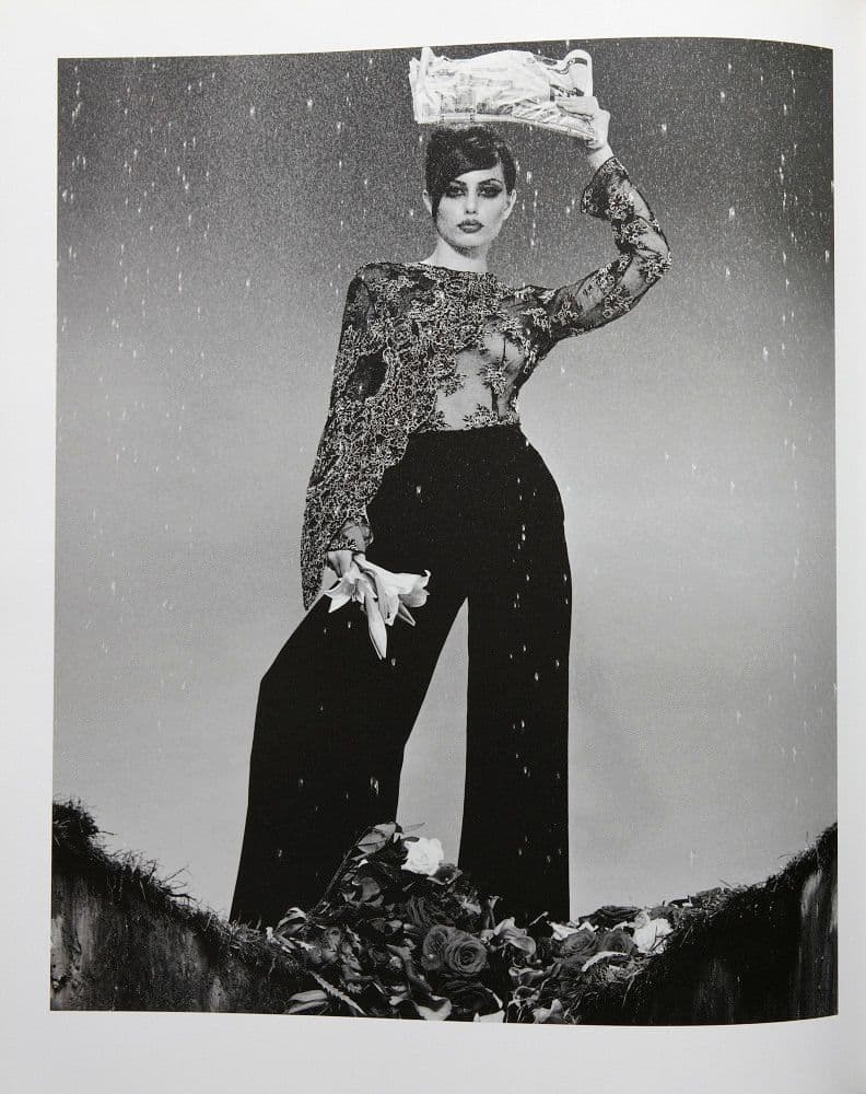 a black and white photo of a woman holding an umbrella