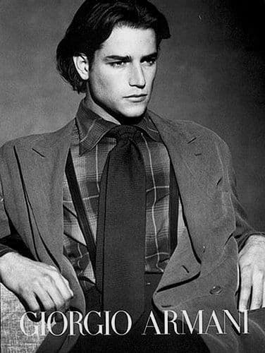 a black and white photo of a man in a suit and tie