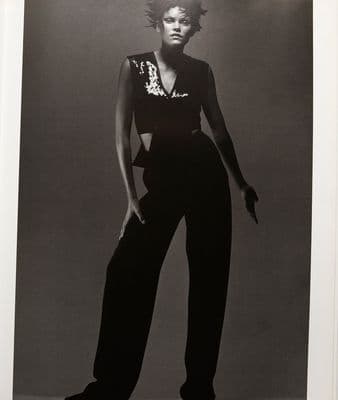 a black and white photo of a woman in a jumpsuit