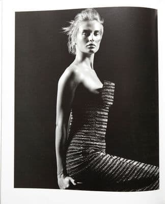 a black and white photo of a woman in a dress