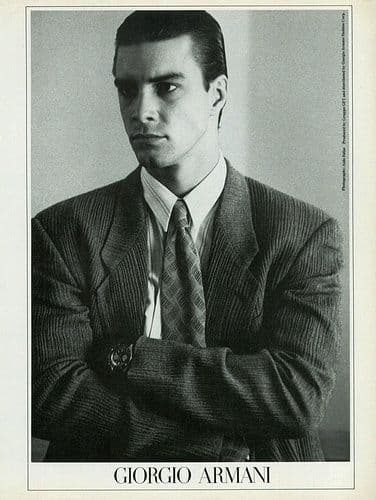 a black and white photo of a man in a suit