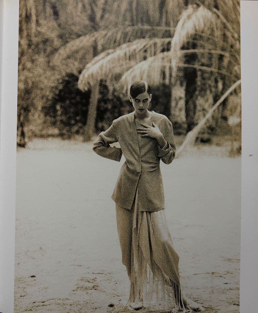 a black and white photo of a woman in a skirt