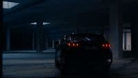 a car parked in a parking garage at night