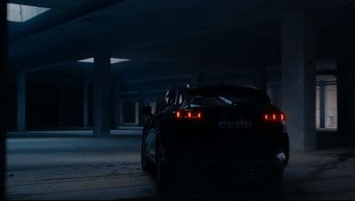 a car parked in a parking garage at night