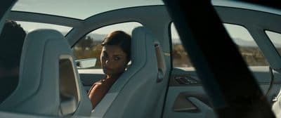 a woman sitting in a car with her head out the window